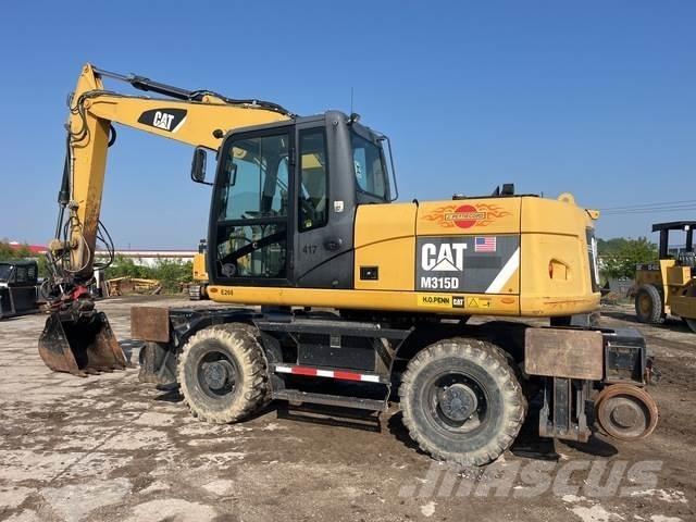 CAT M315D Kolová rýpadla